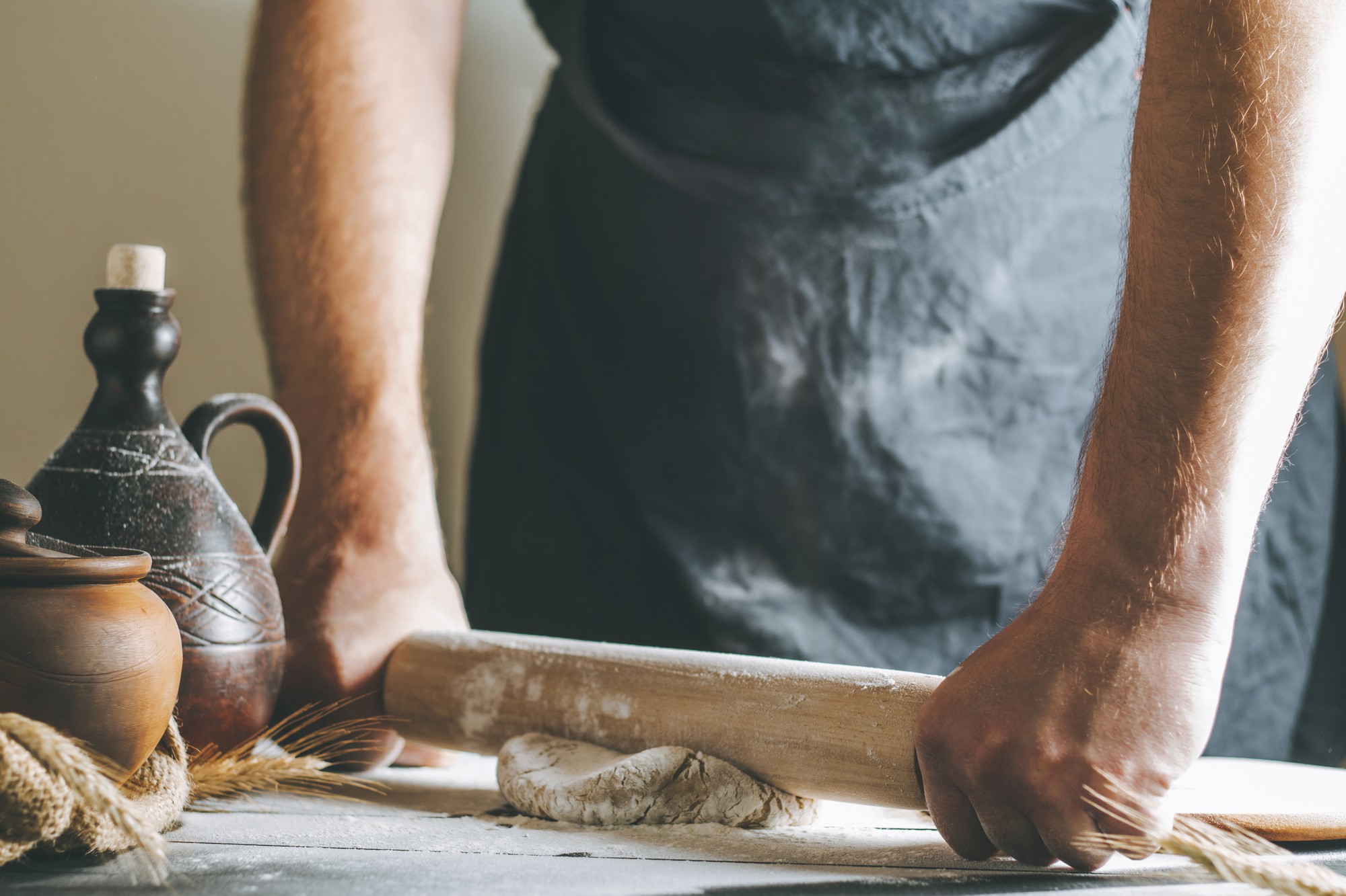 Chef che impasta con cura su piano in legno
